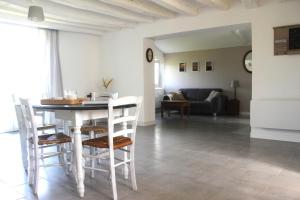 a living room with a table and chairs and a couch at Gîte AnjouLoire in Saint-Mathurin