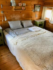 a bedroom with a large bed in a wooden room at Family-Friendly Cabin South Of Oslo in Tjøme