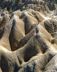 a person standing on top of some rocks at OM homestay in Lāmayūrū