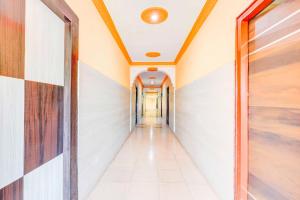 a corridor of a building with white walls and a ceiling at Collection O Rayagada Bus Stand in Rāyagada