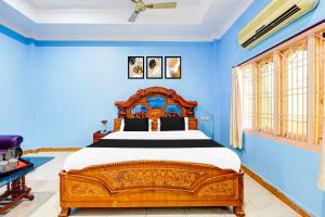a bedroom with a large bed with blue walls at Collection O Rayagada Bus Stand in Rāyagada