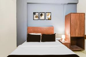 Postel nebo postele na pokoji v ubytování Hotel O Paradise Circle