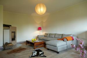 a living room with a couch and a table at Light Flooded Apartment With Sauna in Walow +18 photos
