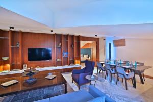 a living room with a couch and a table and chairs at Dosso Dossi Hotels & SPA Downtown in Istanbul