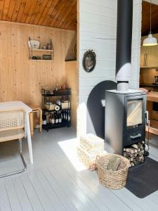 a living room with a fireplace in a house at Fine Details In Forest Setting In Ebeltoft in Ebeltoft