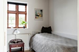 a bedroom with a bed and a window at Pure Farmhouse Idyll For Large Families in Hornsyld