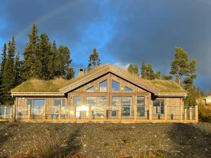 a large house with a grass roof at Modern Cabin With Beautiful Design By Gålåvatn in Gålå