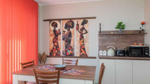 a dining room with a table and a microwave at Flat Lora Pomorie in Pomorie