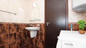 a bathroom with a sink and a mirror on the wall at Flat Lora Pomorie in Pomorie
