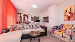 a living room with a couch and a chair at Flat Lora Pomorie in Pomorie