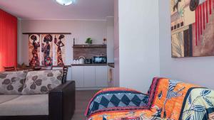 a living room with a couch and a kitchen at Flat Lora Pomorie in Pomorie