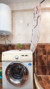 a washer and dryer in a kitchen with at Flat Lora Pomorie in Pomorie