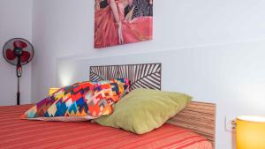 a bedroom with a bed with two pillows on it at Flat Lora Pomorie in Pomorie