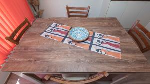 a wooden table with a bowl on top of it at Flat Lora Pomorie in Pomorie +37 photos