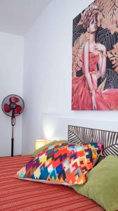 a bedroom with a bed with a painting on the wall at Flat Lora Pomorie in Pomorie
