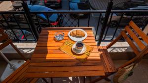 a table with a plate of bread and a cup of coffee at Flat Lora Pomorie in Pomorie