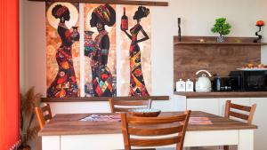 a dining room with a table and a painting on the wall at Flat Lora Pomorie in Pomorie