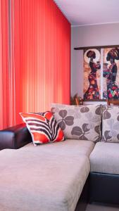 a living room with a couch and red curtains at Flat Lora Pomorie in Pomorie