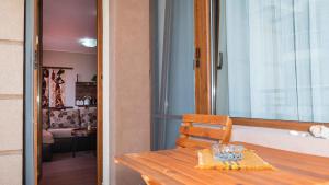 a wooden table and a chair in a room at Flat Lora Pomorie in Pomorie