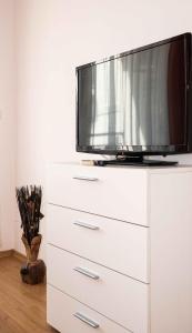 a tv on top of a white dresser at Flat Lora Pomorie in Pomorie
