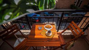 a wooden table with a plate of food on a balcony at Flat Lora Pomorie in Pomorie