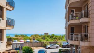 a view of a parking lot between two buildings at Flat Lora Pomorie in Pomorie