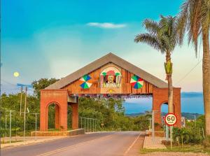 a building with a sign on the side of a road at Casa dos Demeries in Triunfo