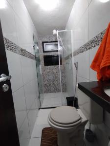 a bathroom with a shower with a toilet and a sink at Casa dos Demeries in Triunfo +36 photos