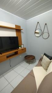 a bedroom with a flat screen tv on a wall at Casa dos Demeries in Triunfo