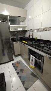 a kitchen with a stove and a counter top at Casa dos Demeries in Triunfo