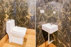 a bathroom with a toilet and a sink at Collection O Palava Dombivali in Mumbai