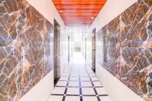 a hallway with marble tiles and a tile floor at Collection O Palava Dombivali in Mumbai