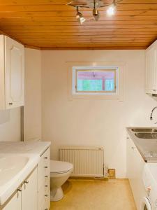 a bathroom with a toilet and a sink and a window at Lakeside Holiday Home With Sauna Near Karlskoga in Karlskoga
