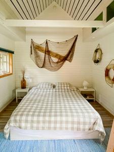 a bedroom with a bed with a net on the wall at Lakeside Holiday Home With Sauna Near Karlskoga in Karlskoga