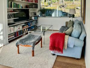 a living room with a couch and a glass table at Your Archipelago Dream On Ingarö in Värmdö