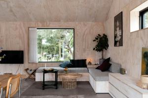 a living room with a couch and a table at Enjoy The Morning With A Dip In The Sea in Odder