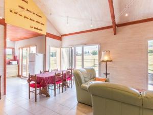 a living room with a couch and a table with chairs at Gîte écologique calme proche Vosges, accueil PMR - FR-1-583-465 in Frahier-et-Châtebier