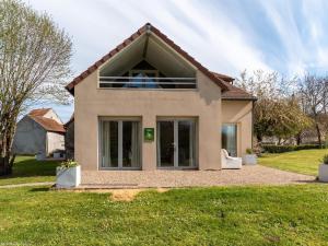 a house with a large window on the front of it at Maison spacieuse avec jardin et vue rivière - FR-1-583-458 in Port-sur-Saône