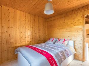 a bedroom with a bed in a wooden room at Charmante maison bois avec piscine et animaux admis - FR-1-583-475 in Vy-le-Ferroux +17 photos