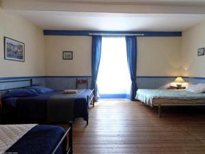 a bedroom with two beds and a window at Gîte familial 6 pers avec billard et salle de jeux - FR-1-583-488 in Anchenoncourt-et-Chazel