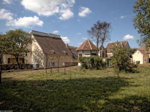 a group of houses in a field with trees at Charmant gîte rénové avec terrasse et parking au cœur de Montagney - FR-1-583-482 in Montagney