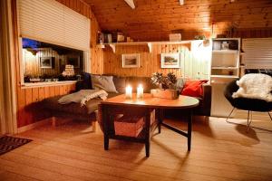 a living room with a table and a couch at Sleep Under The Stars Near Brunsnæs Beach in Broager +7 photos