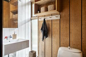 a bathroom with a toilet and a sink at Authentic Friis & Moltke House In Lundo's Nature in Højslev
