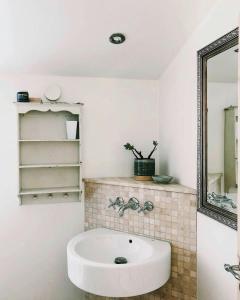 a bathroom with a sink and a mirror at Moments In Relaxed Family House Near Kulhuse in Jægerspris