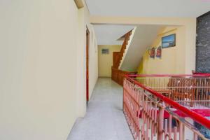 a hallway with a red cage in a house at Collection O Mall Road Near Gurudwara Manali in Manāli