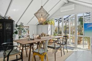 a dining room with a wooden table and chairs at Home Near Stillinge Beach And Bildsø Forest in Slagelse