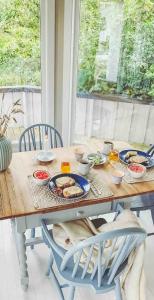 a wooden table with plates of food on it at Charming Holiday Home By Sea Near Stavern in Stavern