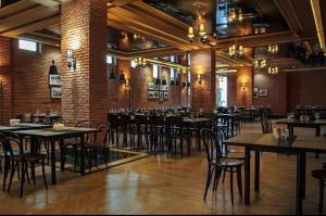 a large room with tables and chairs in a restaurant at Orbi Palace Bakuriani Apartment 402 in Bakuriani