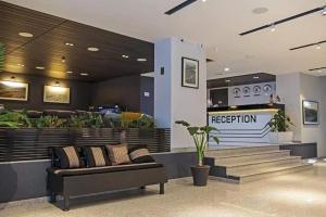 a lobby with a couch in front of a restaurant at Orbi Palace Bakuriani Apartment 402 in Bakuriani