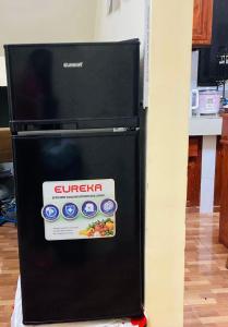 a black refrigerator with a box on the side of it at Brklyn Homestay in Banaue +15 photos